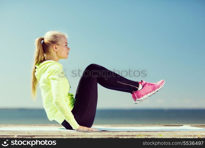 fitness and lifestyle concept - woman doing sports outdoors