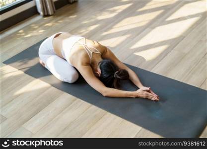 Fitness asian woman doing yoga stretching exercise on mat yoga fitness exercises. Healthy lifestyle Calmness and relax at yoga studio