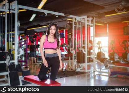 Fitness Asian women Stand in sport gym interior and fitness health club with sports exercise equipment Gym background.