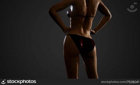 Fitness athletic woman in bikini posing