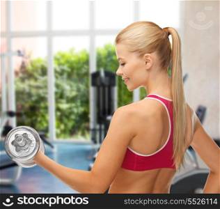 fitness, bodybuilding and gym concept - close up of young sporty woman with heavy steel dumbbell at gym