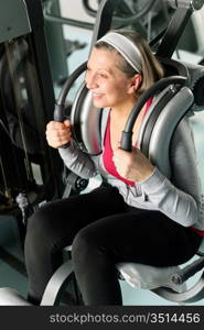 Fitness center senior woman exercise smiling on gym machine