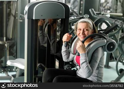 Fitness center senior woman exercise smiling on gym machine