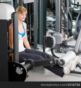 Fitness center young woman exercise legs on gym machine workout