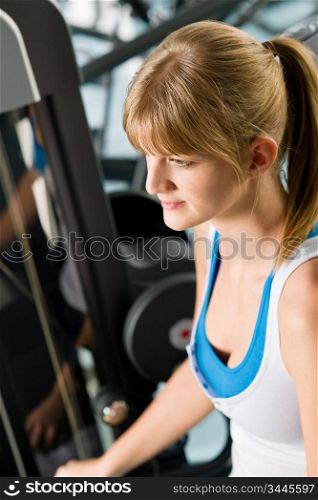 Fitness center young woman exercise on gym machine workout