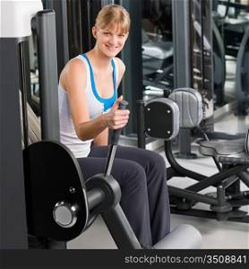 Fitness center young woman exercise on gym machine workout