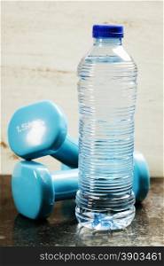 Fitness concept with dumbbells and bottle of water