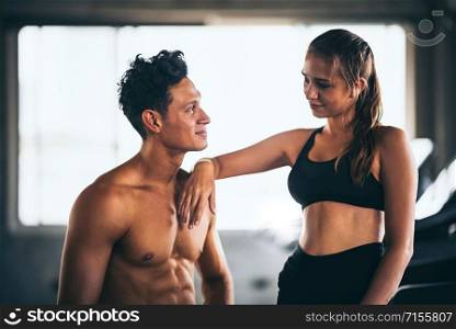 Fitness couple - woman and man in sport gym