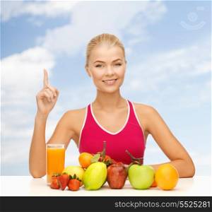 fitness, diet and food concept - young woman with organic food or fruits holding finger up