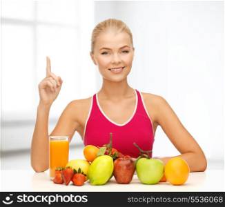 fitness, diet and food concept - young woman with organic food or fruits holding finger up