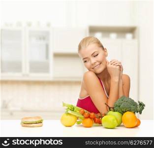 fitness, diet and healthcare concept - doubting woman with fruits and hamburger