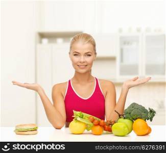 fitness, diet and healthcare concept - smiling woman with fruits versus hamburger