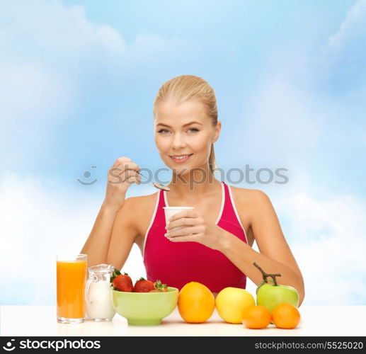 fitness, diet, health and food concept - young woman eating healthy breakfast
