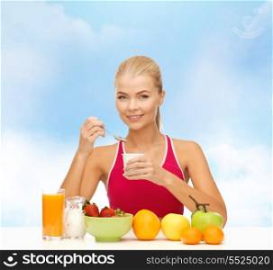 fitness, diet, health and food concept - young woman eating healthy breakfast