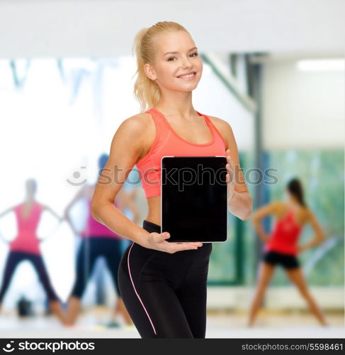 fitness, dieting, technology and sport concept - smiling sporty woman showing tablet pc blank black screen