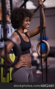 Fitness dip ring african american young woman relaxed after workout at gym dipping exercise