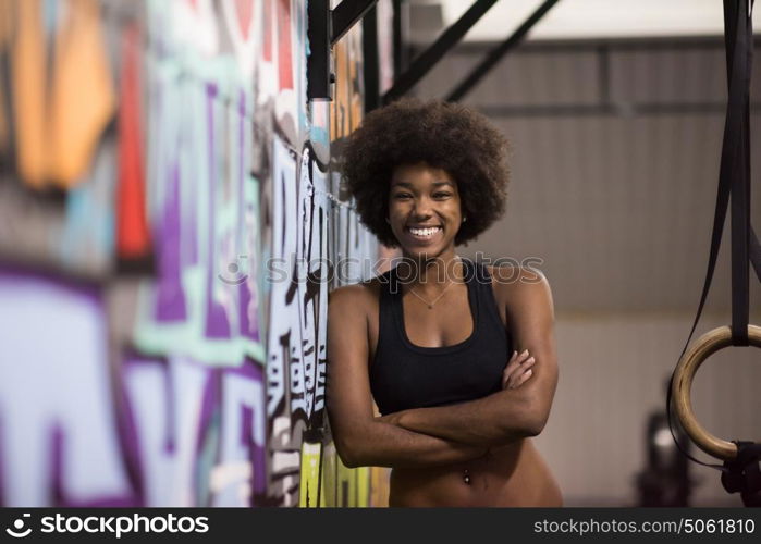 Fitness dip ring african american young woman relaxed after workout at gym dipping exercise