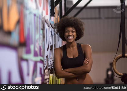 Fitness dip ring african american young woman relaxed after workout at gym dipping exercise