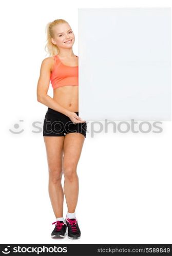 fitness, exercising and advertising concept - smiling sportswoman with white blank board