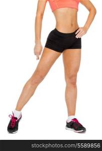 fitness, exercising and dieting concept - close up of female legs in sportswear