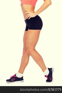 fitness, exercising and dieting concept - close up of female legs in sportswear