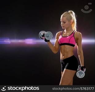 fitness, exercising and dieting concept - sporty woman with heavy steel dumbbells