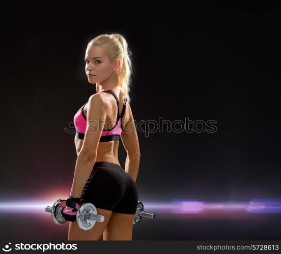 fitness, exercising and dieting concept - sporty woman with heavy steel dumbbells from back