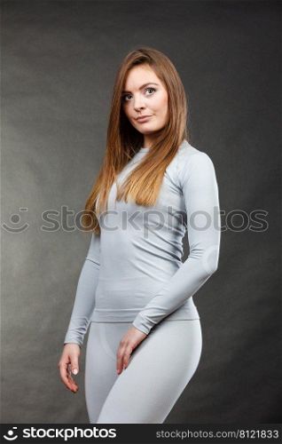 Fitness fashion costume active sporty concept. Gorgeous girl posing in underwear. Attractive smiling lady presenting thermoactive clothing.. Sport fit woman in thermal underwear.
