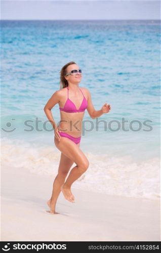 Fitness Female Athlete Jogging On The Sea Shore