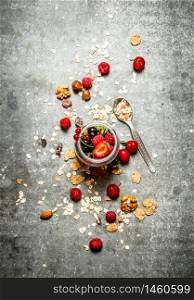 Fitness food. Berries with muesli and nuts. On the stone table.. Fitness food. Berries with muesli and nuts.