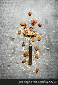 Fitness food. Cereal and dried fruits in spoon. On the stone table.. Fitness food. Cereal and dried fruits in spoon.