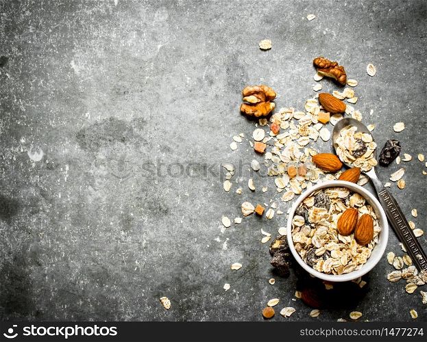 Fitness food. Cereals with dried fruit in the Cup. On the stone table.. Fitness food. Cereals with dried fruit in the Cup.