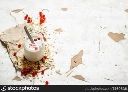 Fitness food. Milk cream with oats and ripe currants. On rustic background.. Fitness food. Milk cream with oats and ripe currants.