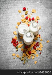 Fitness food. Milk with cereal and berries. On the stone table.. Fitness food. Milk with cereal and berries.