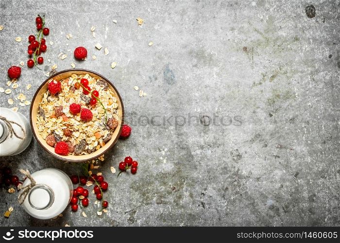 Fitness food. Muesli with berries and milk. On the stone table.. Fitness food. Muesli with berries and milk.