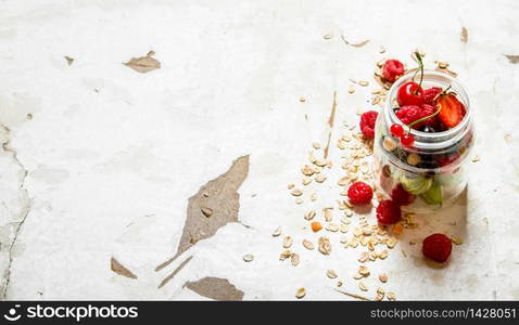 Fitness food. Ripe wild berries with the oats. On rustic background.. Fitness food. Ripe wild berries with the oats.