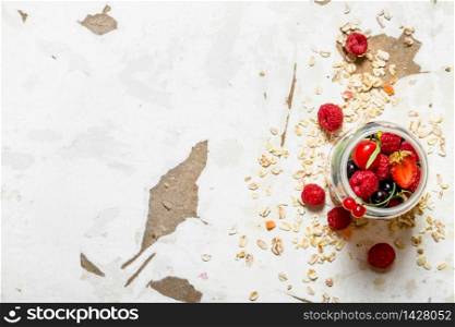 Fitness food. Ripe wild berries with the oats. On rustic background.. Fitness food. Ripe wild berries with the oats.