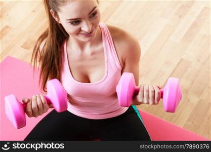 Fitness girl fit woman with dumbbells, doing exercise with dumb bells training with weights at home