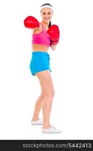 Fitness girl in boxing gloves punching