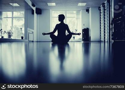 fitness girl yoga silhouette in the room