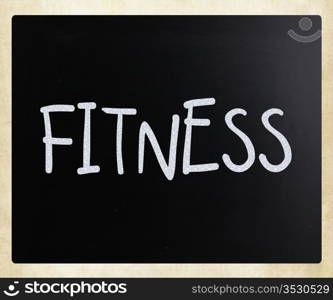 ""Fitness" handwritten with white chalk on a blackboard."