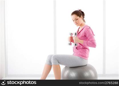 Fitness happy tired woman exercise dumbbell ball on white