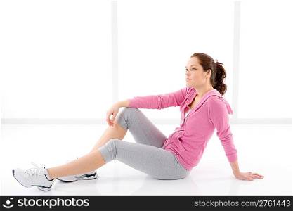Fitness happy woman in sportive outfit on white