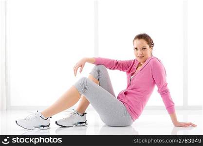 Fitness happy woman in sportive outfit on white