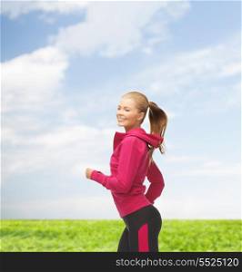 fitness, health and diet concept - beautiful sporty woman running or jumping