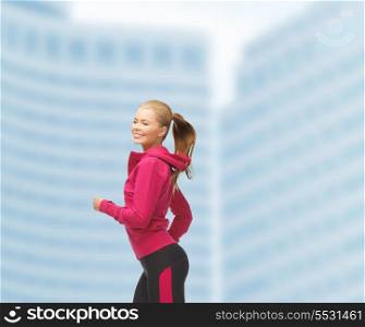 fitness, health and diet concept - beautiful sporty woman running or jumping