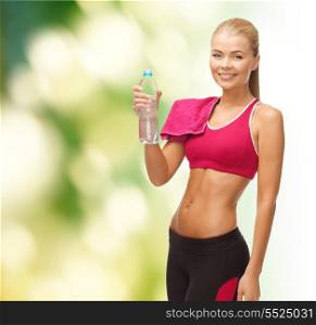 fitness, health and diet concept - sporty woman with bottle of water and towel