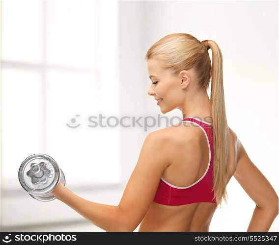 fitness, health and diet concept - young sporty woman with heavy steel dumbbell