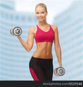 fitness, health and diet concept - young sporty woman with heavy steel dumbbells