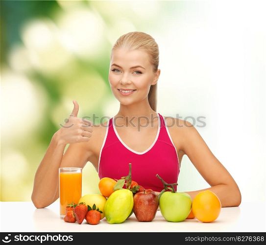 fitness, healthcare and diet concept - smiling young woman with organic food or fruits on table shwoing thumbs up